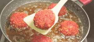 chicken mayonnaise kababs frying in a pan